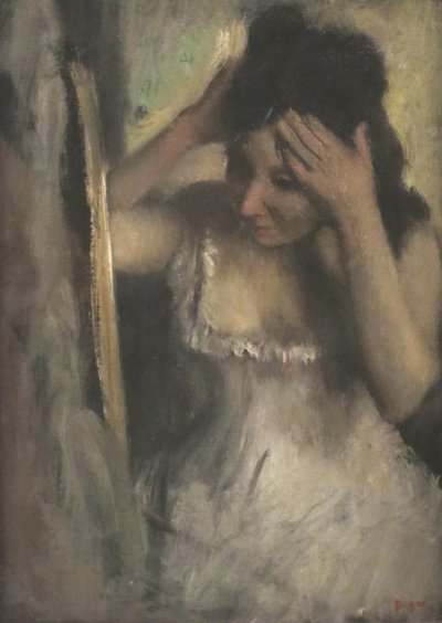 Woman Combing Her Hair Before a Mirror by Edgar Degas